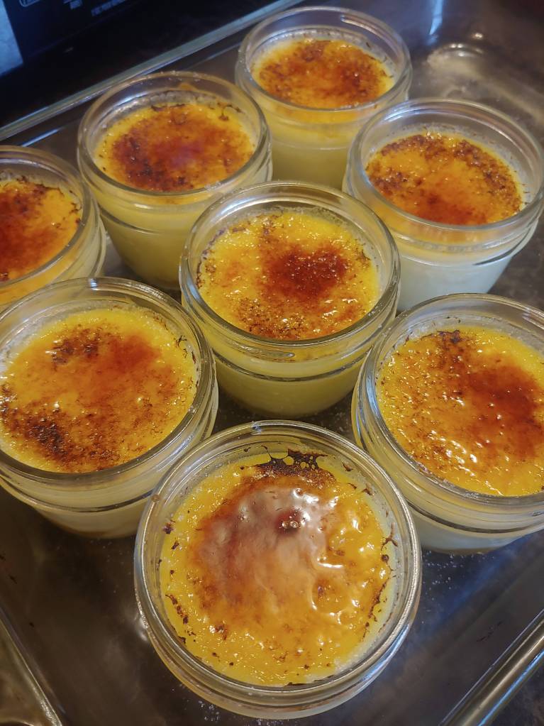 The caramelized sugar topping. It should harden and 'crack' when a spoon digs into the Crème Brulee